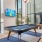 a pool table in a room with large windows