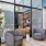 room with seating and a bar and large windows